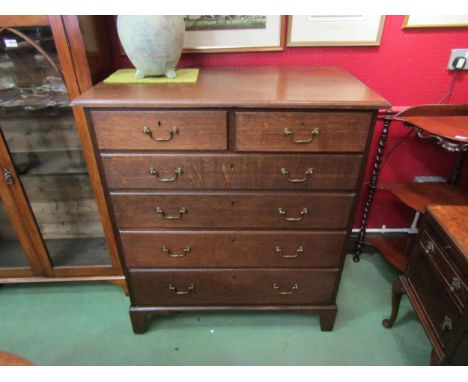 Circa 1780 a George III oak country chest of two short over four graduating long drawers with brass swan neck handles over br
