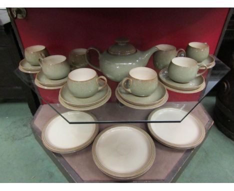 A Denby tea set comprising teapot, six trios, sugar bowl and milk jug together with six dinner plates in sage green 