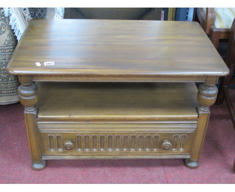 Ercol TV Stand, with drop leaf to fit in a corner, drawer with knulled decoration, on bun feet, bearing label.
