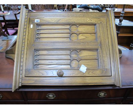 Ercol Corner Cupboard, with Gothic style panelled door, bearing label.