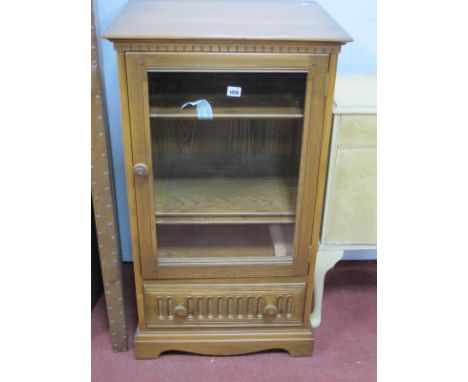 Ercol Hi-Fi Cabinet, with glazed door, drawer with knulled decoration, on bracket feet.