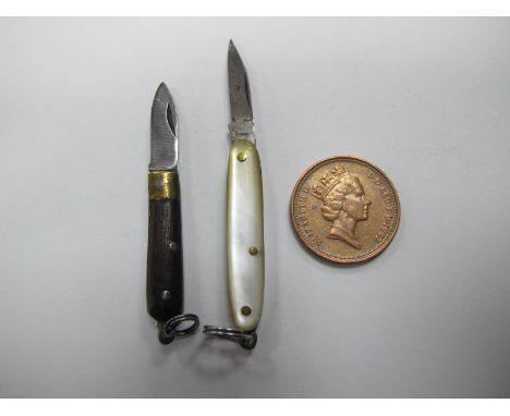 Miniature Pen Knives, circa 1900, one with mother of pearl scales, 55cm open, 30mm closed, the other with ebony scales 45mm o