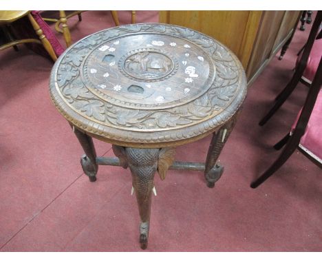 XX Century African Hardwood Table, with a carved circular top, carved elephant head trunk united by 'X' stretcher.