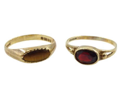 Gold oval garnet ring and a gold tiger's eye ring, both hallmarked 9ctCondition Report:Approx 2.1gm, sizes K-L (shanks slight