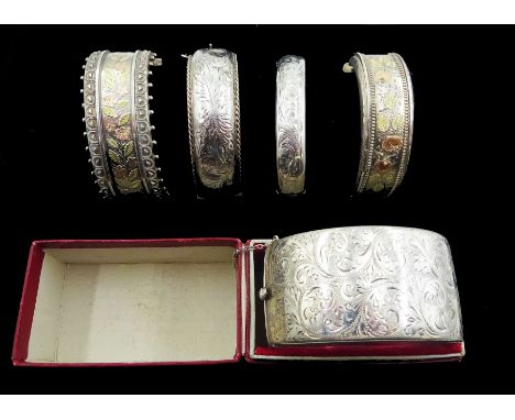 Two 19th/early 20th century silver bangles with two tone foliate bright cut decoration, one stamped Standard, the other sterl