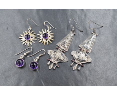 Three pairs of white metal earrings stamped 925, one pair of chandelier form bearing enamelled decoration and an etched two h