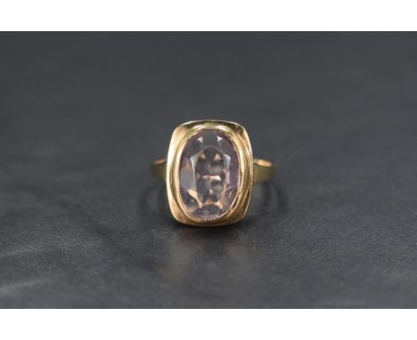 A yellow metal presumed gold amethyst set signet style ring, the oval cut amethyst measuring approximately 3.20ct, in a step 