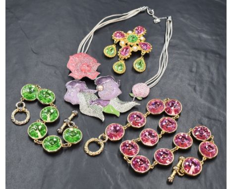 A Swarovski enamel and diamante necklace in shades of pink and green on a grey cord loop, along with three pieces of Sarah Bo