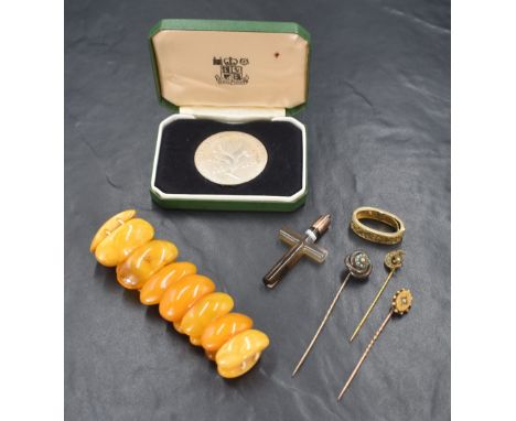 A cased silver National Trust 25years service medal bearing presentation name to edge, a carved agate cross pendant with yell