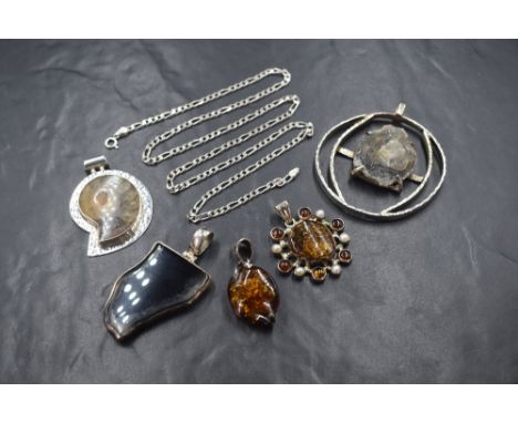Five polished stone and fossil silver mounted pendants including Baltic amber, ammonite etc, with a 24' silver figaro link ch