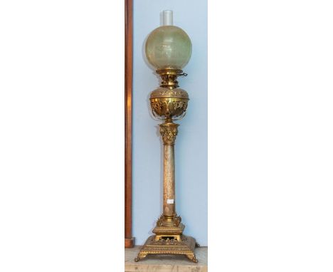 A decorative Victorian brass and alabaster table oil lamp, with classical column, green tinted etched shade and chimney, 100c