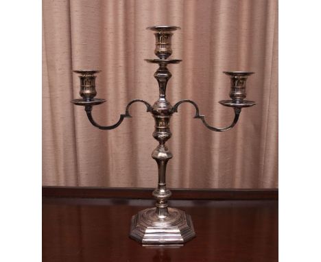 An Elizabeth II silver candelabrum, in George II style, with candlestick stem and two branch/three light dipped branches with