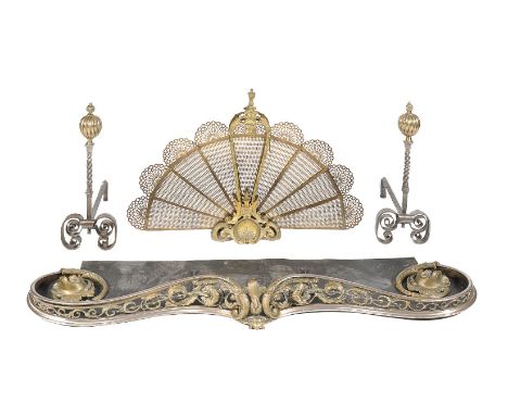 A steel and brass mounted fender in Rococo Revival style, mid 19th century, the serpentine front with openwork scrolling foli