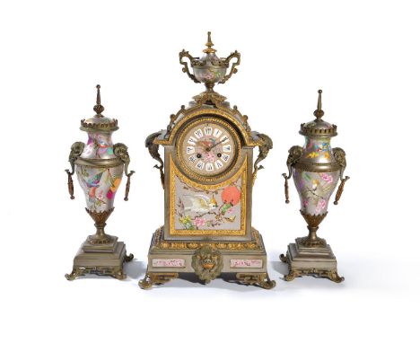 ‡A silvered and parcel gilt brass porcelain mounted clock garniture in the Oriental taste, eight day gong striking movement w