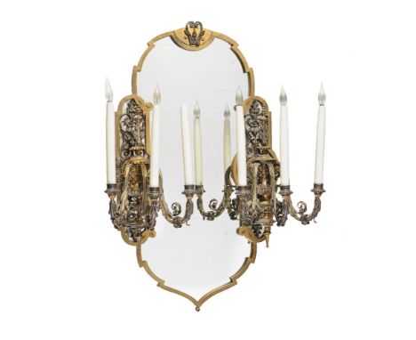 A pair of French parcel gilt and silvered metal six light girandoles, late 19th century, the foliate and lobed urn sockets on