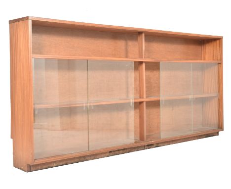 A large British Modern Design retro 20th century teak wood &amp; glass cabinet bookcase. The bookcase with top shelf over fou