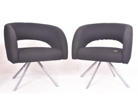 Boss Design - a pair of vintage upholstered black office armchairs. Each tub armchair with curved upholstered backrest, raise