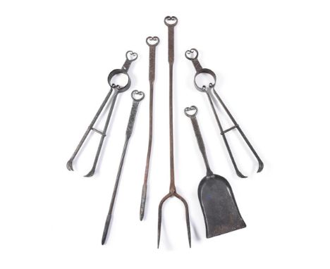 A GROUP OF SIX COTSWOLD SCHOOL FIRE TOOLS  IN THE MANNER OF ERNEST GIMSON, CIRCA 1900-1910  Each with characteristic scrollin