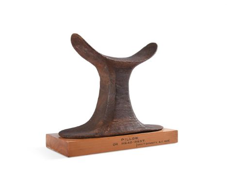 AN EGYPTIAN WOOD HEADREST NEW KINGDOM, CIRCA 1567-1085 B.C.  With curved neck support, with columnar stand and flared base mo