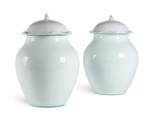 A PAIR OF WHITE GLAZED VASES AND COVERS IN QINGBAI STYLE, 19TH/20TH CENTURY  Approximately 40cm high  Together with an Qingba