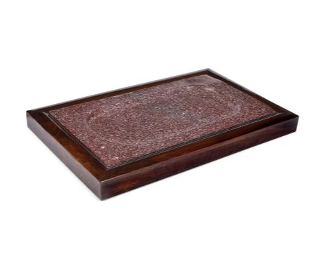 Y&nbspA PORPHYRY SHALLOW TRAY  POSSIBLY CIRCA 2ND-4TH CENTURY A.D. OR LATER  Set within a 19th century rosewood frame 60cm wi
