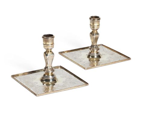 A MATCHED PAIR OF GEORGE II SILVER-GILT CANDLESTICKS  DAVID WILLAUME, LONDON 1729 AND WILLIAM GOULD, LONDON 1747  With cylind