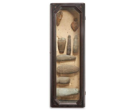 A GLAZED FRAMED CASE CONTAINING TWO PALAEOLITHIC FLINT HAND AXES AND SEVEN NEOLITHIC STONE AXES AND HAMMERS  CIRCA 2000 B.C. 