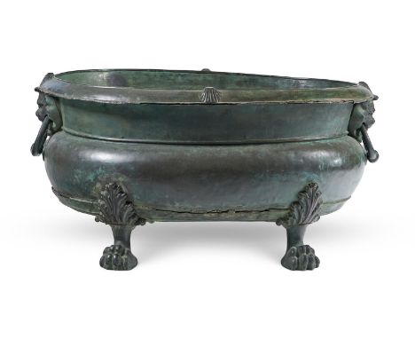 A BRONZED WINE COOLER  ITALIAN, 17TH CENTURY  Of cistern form, scallop shell decorated lip above waisted oval body, twin ring