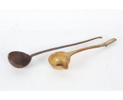 George II horn toddy ladle inset with a George II shilling together with a 19th century iron ladle (2)