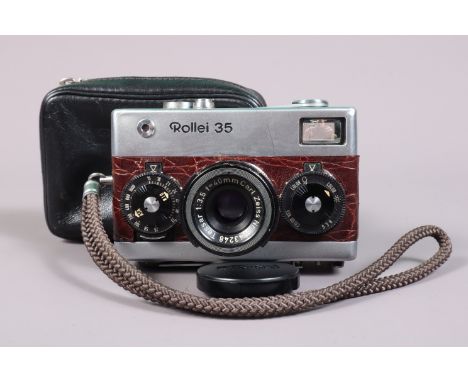 A Rollei 35 Compact Camera, chrome, brown, recovered in simulated Crocodile skin,  made in Germany, serail no 3051633, shutte