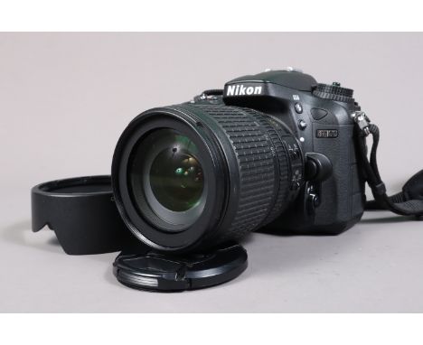 A Nikon D7100 DSLR Camera, serial no 4518410, powers up, shutter working, flash working, appears to function as should, body 