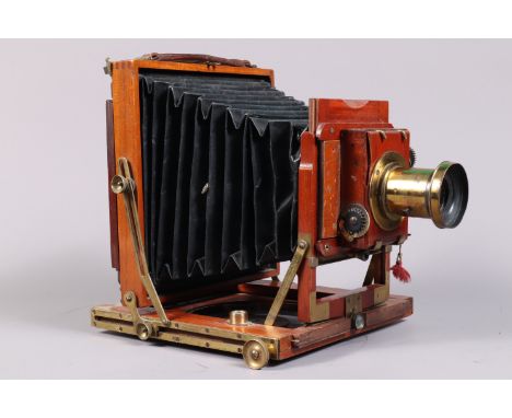 A Half Plate Mahogany and Brass Field Camera, tapered square-cornered black bellows, double extension, focusing screen presen