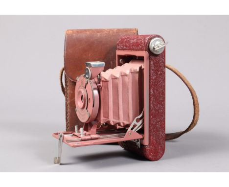 An Eastman Kodak Rainbow Hawk-Eye Vest Pocket Camera, circa 1930, red body, rose bellows for 4 x 6cm format on 127 roll film,