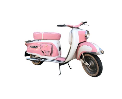 A very cool, vintage 1960s Puch Pony Scooter in pink and white color, without license plate, in good, working condition. Size