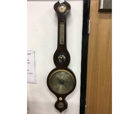 An oak case barometer with thermometer level and mirror.