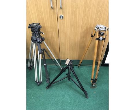 Three camera tripods. A Vinton and Vision (broken), small Velbon D-600 and a vintage wooden Miller Tripod.