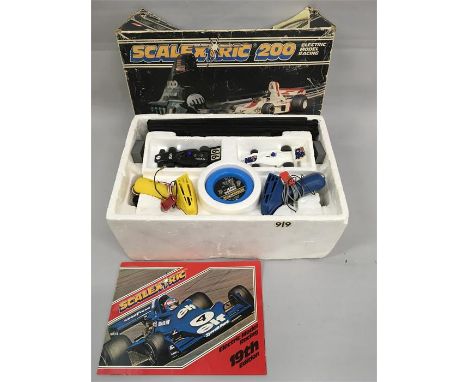 A vintage electronic  Scalextric 200 racing set with original box and instructions together with extra track.