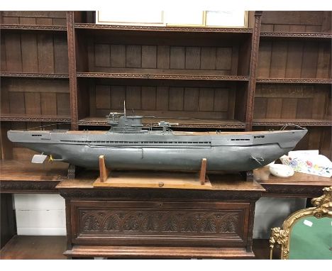 A scale model of a class 2 submarine in gray with tower gun battery once radio controlled 