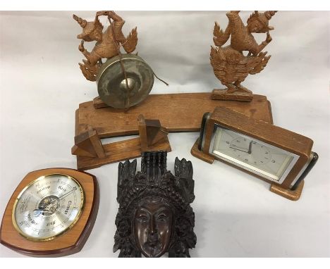 A box of wooden items. A clock, gong, barometer etc