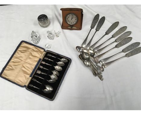 A mixed lot including silver topped dressing table pot a clock in case, silver plated flatware, Swarovski ornaments, and a Be