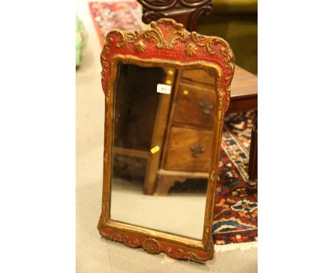 A Georgian wall mirror, in red and gilt frame decorated shells and scrolls, 19 3/4" x 12" 