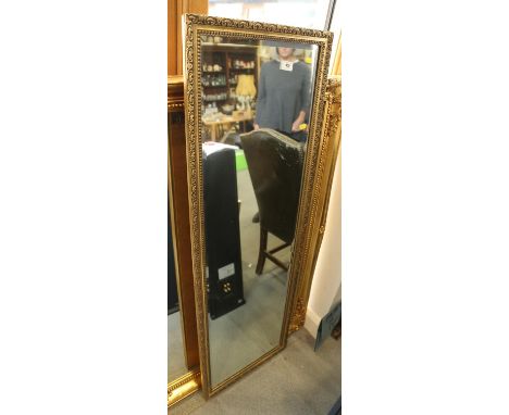 A rectangular gilt framed slip mirror, 50" x 17" 