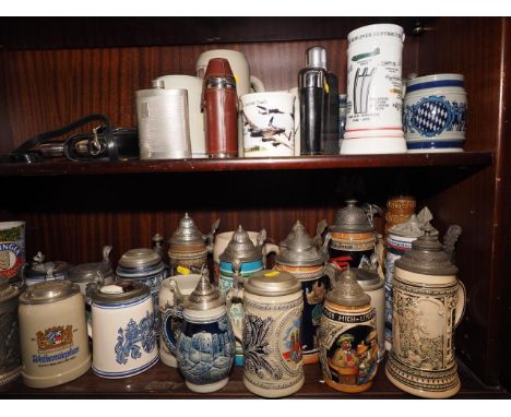 Three Goebel blue and grey tankards, a quantity of other relief decorated tankards, hip flasks and other items 