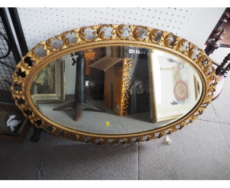 A 19th century oval bevelled wall mirror, in gilt gesso frame, 32" x 22" 