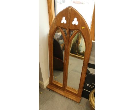 A carved and pierced oak Gothic lancet framed wall mirror with shelf, 45" high x 22" wide overall 