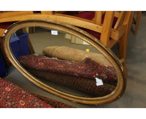 A 19th century oval gilt framed wall mirror, 36" x 22" 