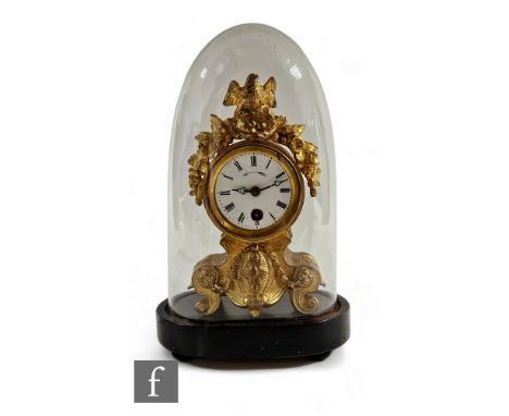 A small 19th Century French gilt metal mantle clock, the dial surmounted with a bird's nest and eggs, under a glass dome, on 