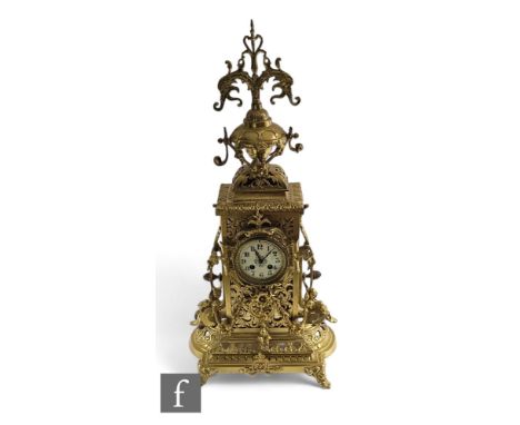 A large Victorian style brass mantle clock in the Renaissance style, Arabic dial with eight day striking movement, on a platf