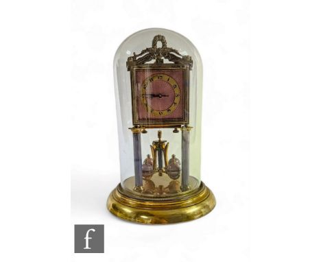 An early 20th Century 365 day mantle clock, the square pink guilloche enamel dial on reeded pillars and enamel ball movement,
