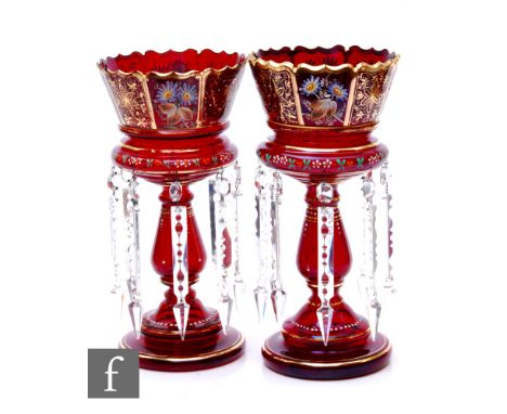 A pair of late 19th Century ruby glass table lustres, each with a stepped circular foot, baluster stem and ovoid bowl with pe